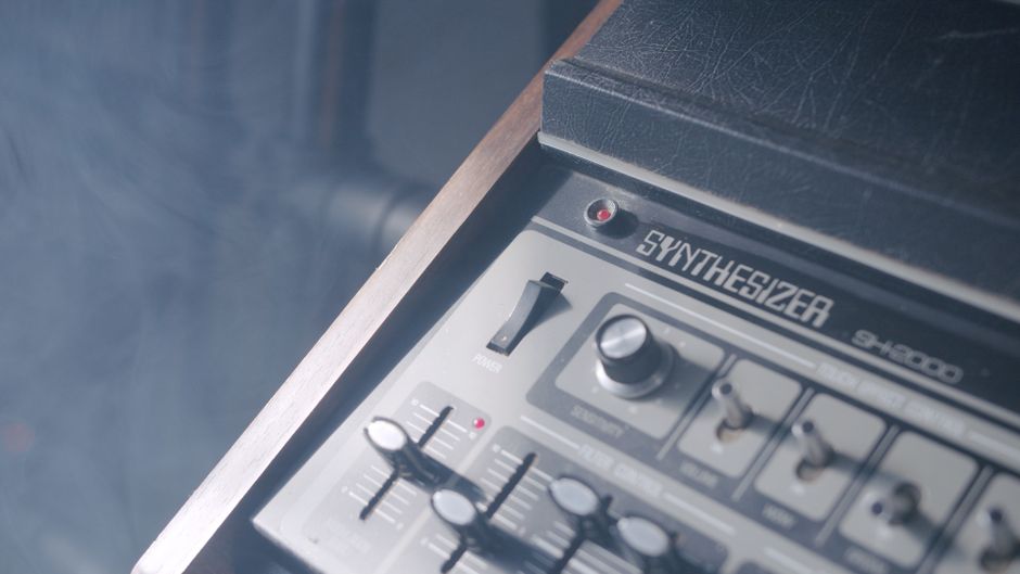 Detailed view of a synthesizer with knobs and electronic controls, perfect for music production themes.